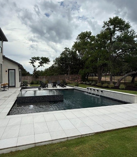 Custom pool with champagne spa and waterfalls in Bee Cave, TX