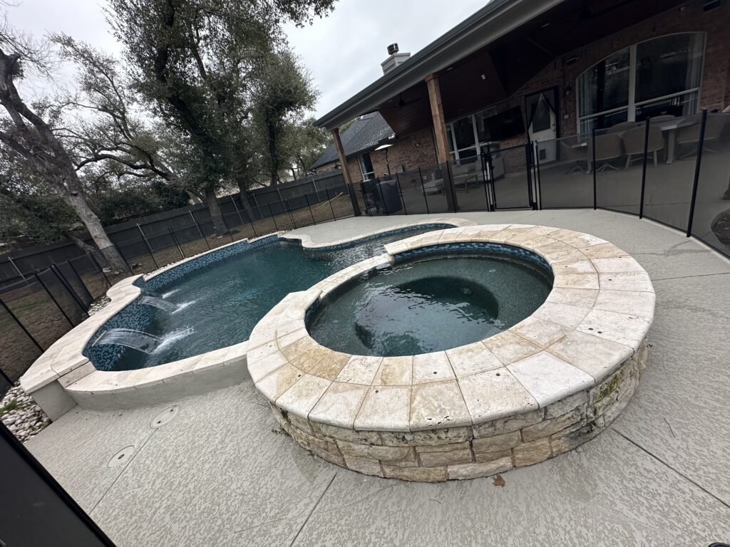 Freeform pool with raised spa in Bee Cave, TX by Renaissance Pools