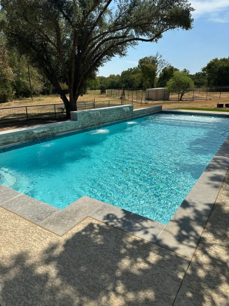 Finished pool with raised stone wall and waterline tile in Austin