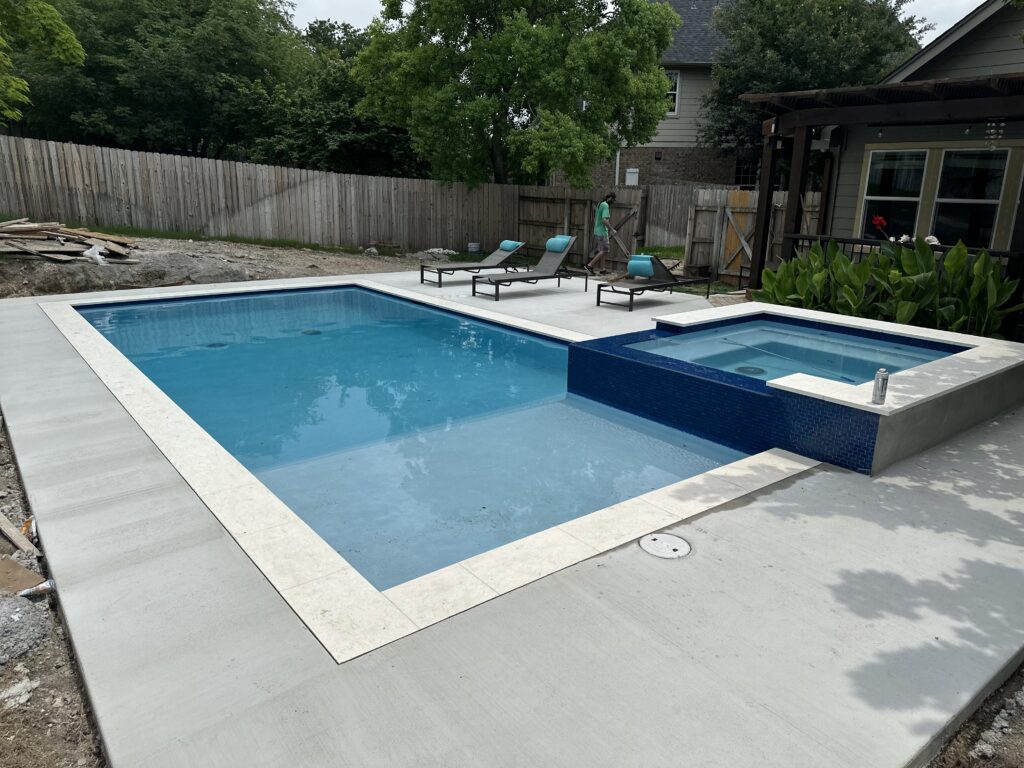 Custom pool with raised spa in Bee Cave, TX by Renaissance Pools