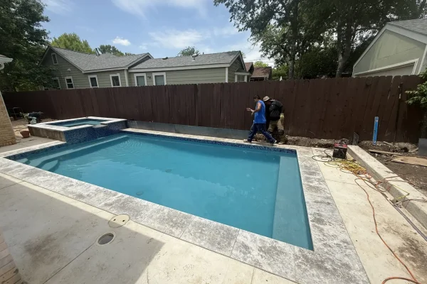 Rectangular pool with spa nearing completion in Austin