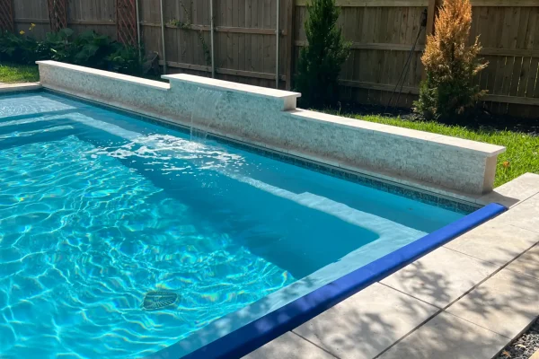 Pool with sheer descent water feature and blue tile